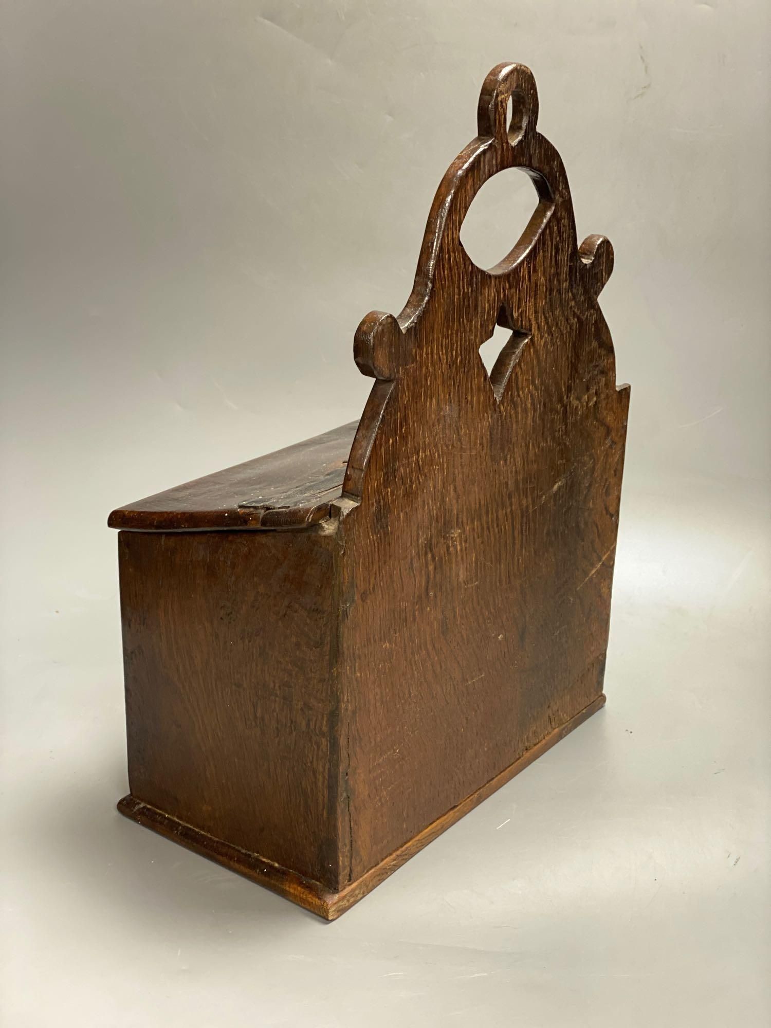 An 18th century oak candle box, cover with studded leather hinge, 28cm wide